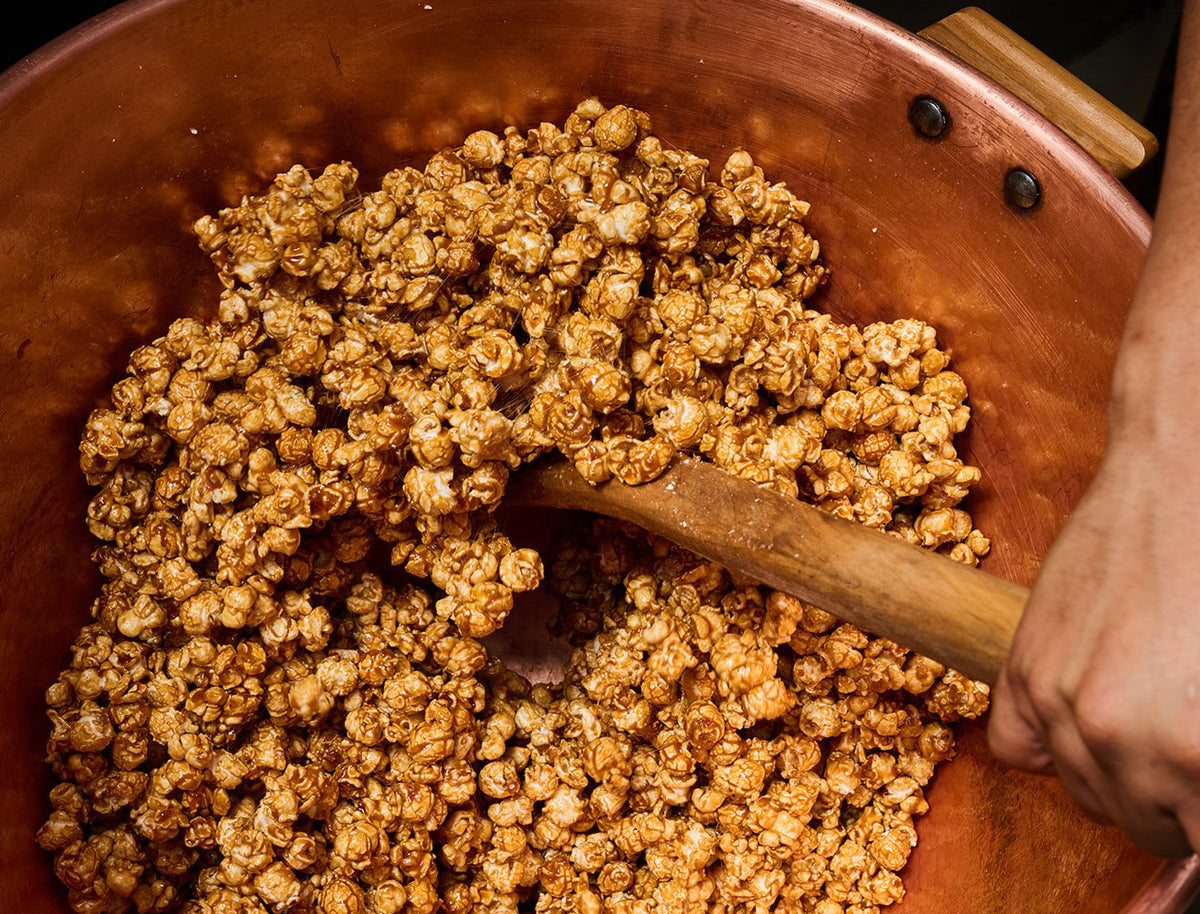Caramel popcorn being hand-mixed in a copper kettle at Johnson's Popcorn in Ocean City, NJ